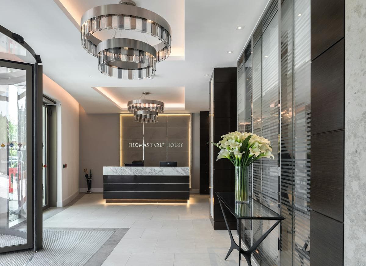 Polished stone reception with sculptural chandeliers and bespoke interior finishes